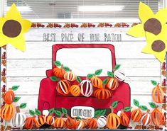 a red truck decorated with sunflowers and paper decorations