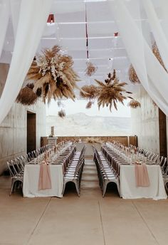 tables set up for an event with white draping