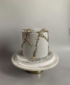 a white cake with gold decorations on top