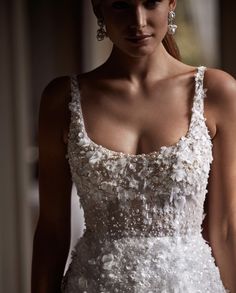 a woman in a white dress with flowers on it