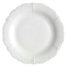 a white plate with an ornate design on the rim and bottom, against a white background