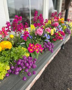 colorful flowers are growing in the window sill