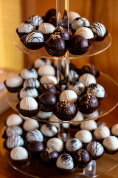 three tiered tray with chocolates and candies on it