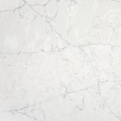 a white marble textured surface with some black spots