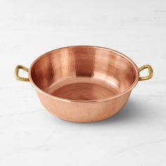 an empty copper bowl on a marble surface