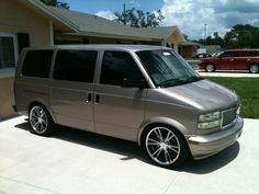 a silver van parked in front of a house