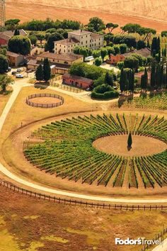 an aerial view of a farm with trees and buildings