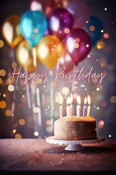 a birthday cake with lit candles and balloons in the background that say happy birthday to you