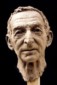 an old man's head is made out of clay with a toothpick