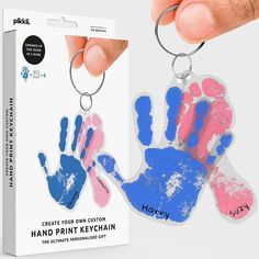 a handprint keychain is being held by a person's hand with the word, create your own custom handprint keychain