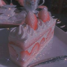 there is a piece of cake with white frosting and strawberries on the top