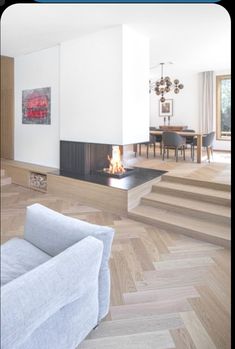 a living room filled with furniture and a fire place in the middle of it's floor