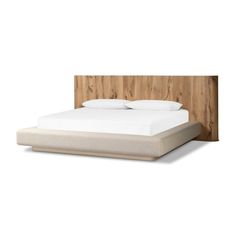 a bed with a wooden headboard and white sheets