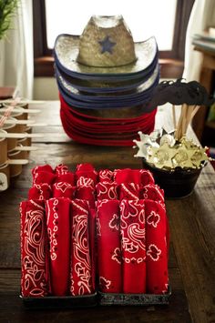 a table topped with lots of red napkins