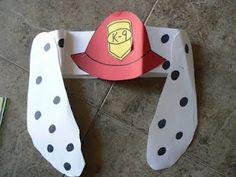 a paper cut out of a fireman's hat with polka dots on the floor