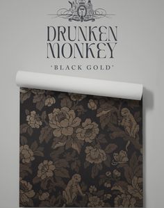 the wallpaper is black and gold with flowers on it, as well as an ad for drukken monkey