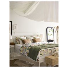 a bedroom with a bed, dresser and mirror on the wall next to each other