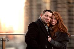 a man and woman standing next to each other in front of a cityscape