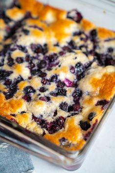 a casserole dish with blueberries and cheese