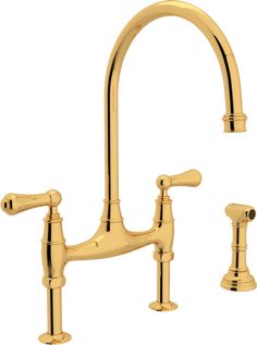 an antique style kitchen faucet with two handles and side sprayers in polished brass