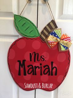 an apple door hanger with the name mr and mrs mariah on it