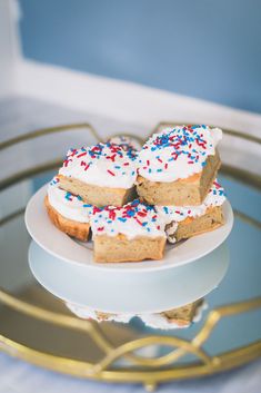 three pieces of cake on a plate with sprinkles