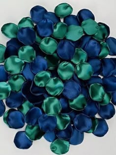 a pile of blue and green satin flowers