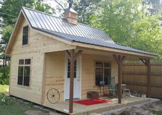 a small wooden cabin with a metal roof