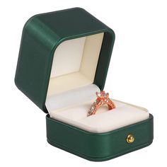 an open green box with a ring in it