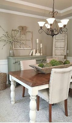 a dining room table with chairs and a bowl of food on it's centerpiece