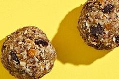 two granola balls sitting on top of a yellow surface