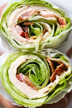 two lettuce wraps filled with bacon and other toppings on top of each other