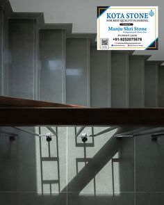 an advertisement for kota stone is shown on the wall next to a stair case