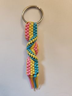 a keychain made out of colorful beads on a white surface with a metal ring