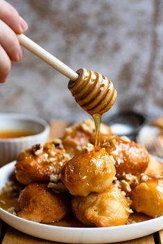 a white plate topped with food and a honey drizzled on top of it