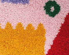 the rug is made up of different colors and shapes