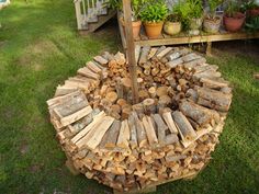 a pile of wood sitting on top of a lush green field