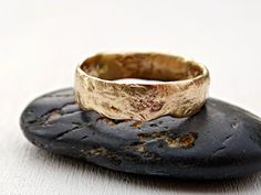 a gold ring sitting on top of a rock