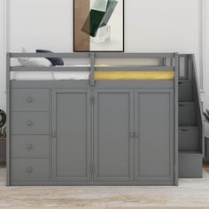 a gray bunk bed with drawers underneath it