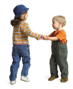 two young boys are holding hands and smiling at each other while standing in front of a white background