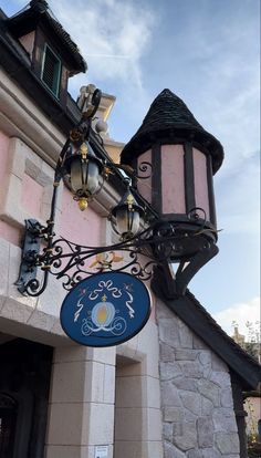 a sign on the side of a building that has a light fixture attached to it