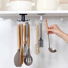 the kitchen utensils are hanging on the wall