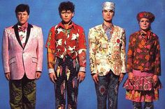 an album cover with three men in colorful outfits