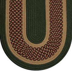 an oval rug with the letter u in red, green and tan colors on it