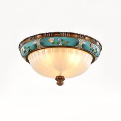 an ornately decorated ceiling light fixture against a white background with no one in it