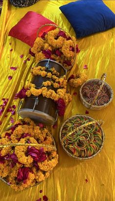 an arrangement of flowers on a yellow table cloth