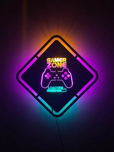 a neon sign that says gamer zone with a video game controller in the middle of it