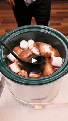 a pot filled with marshmallows on top of a table