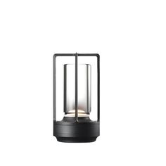 a black lantern with two lit candles in it on top of a white background,