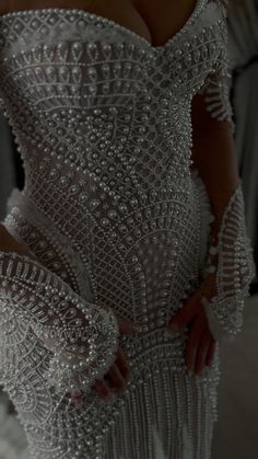 the back of a woman's dress with beading on it